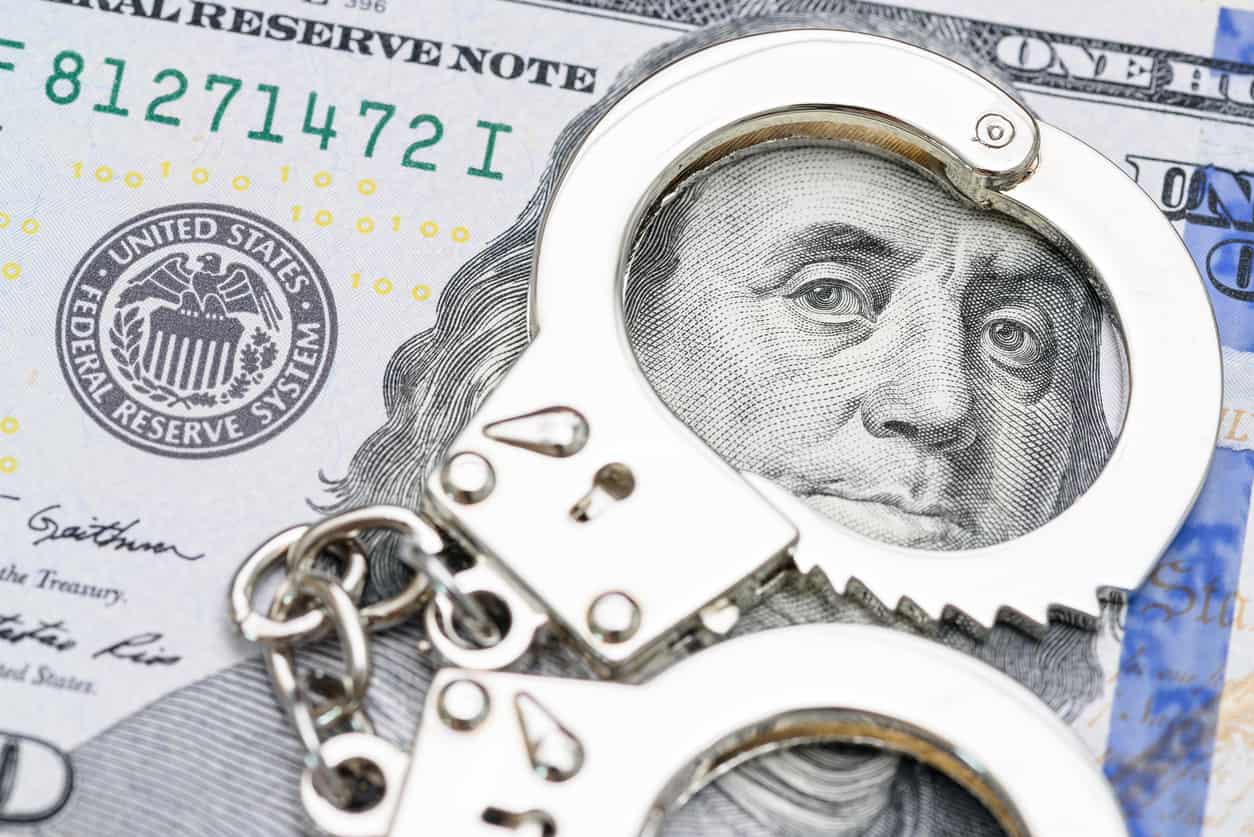 Money laundering charges in Florida symbolized by handcuffs on cash