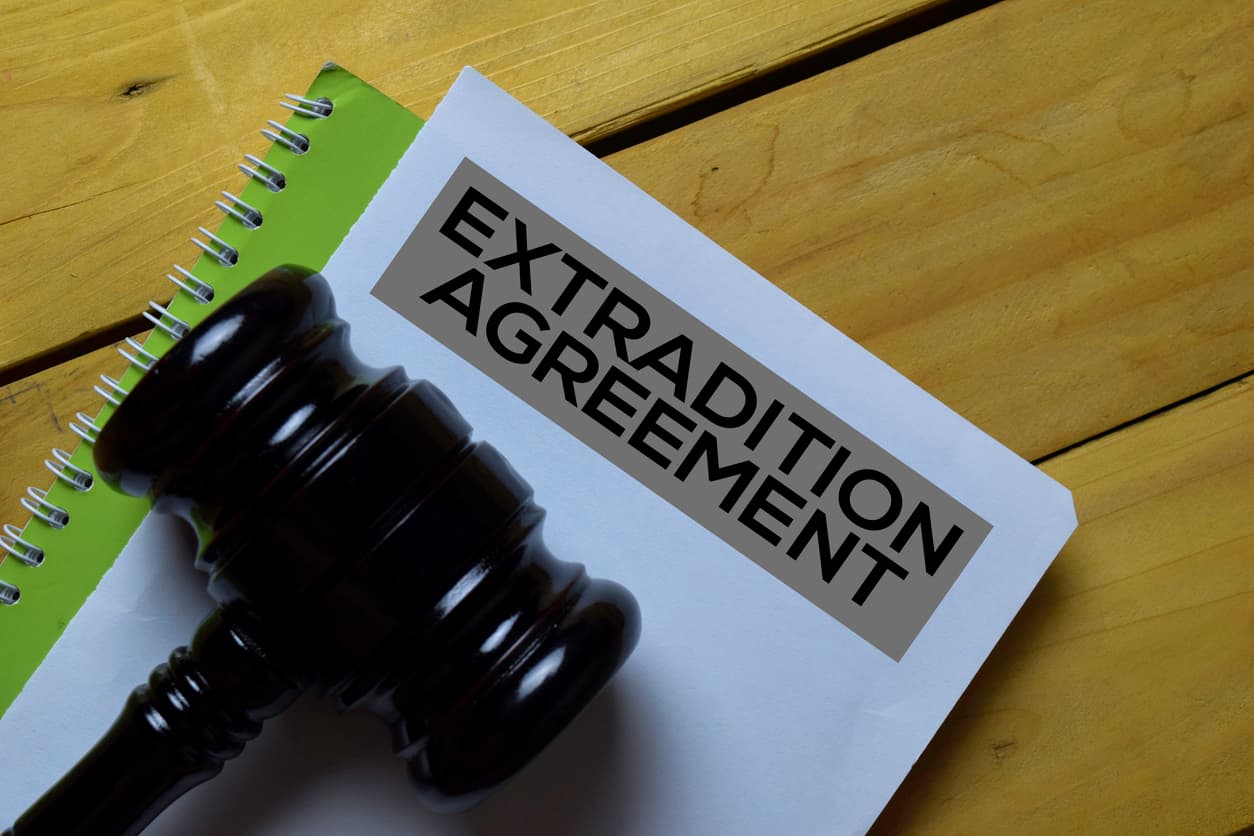 Extradition agreement document with gavel, representing legal rights and international criminal law.