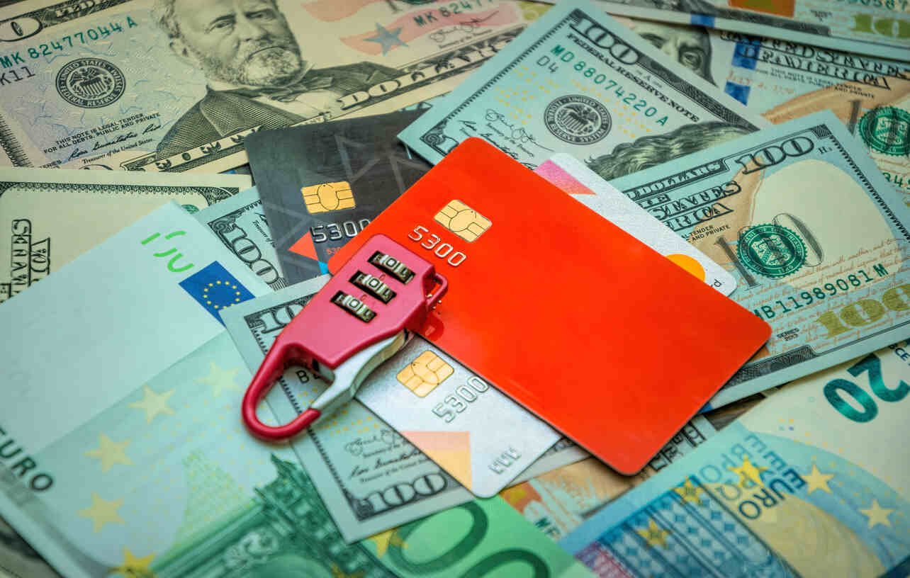 A close-up shot of several stacks of rolled-up hundred-dollar bills, held together by rubber bands. This image represents the financial assets involved in money laundering and highlights the risks of federal investigations for financial institutions and clients.