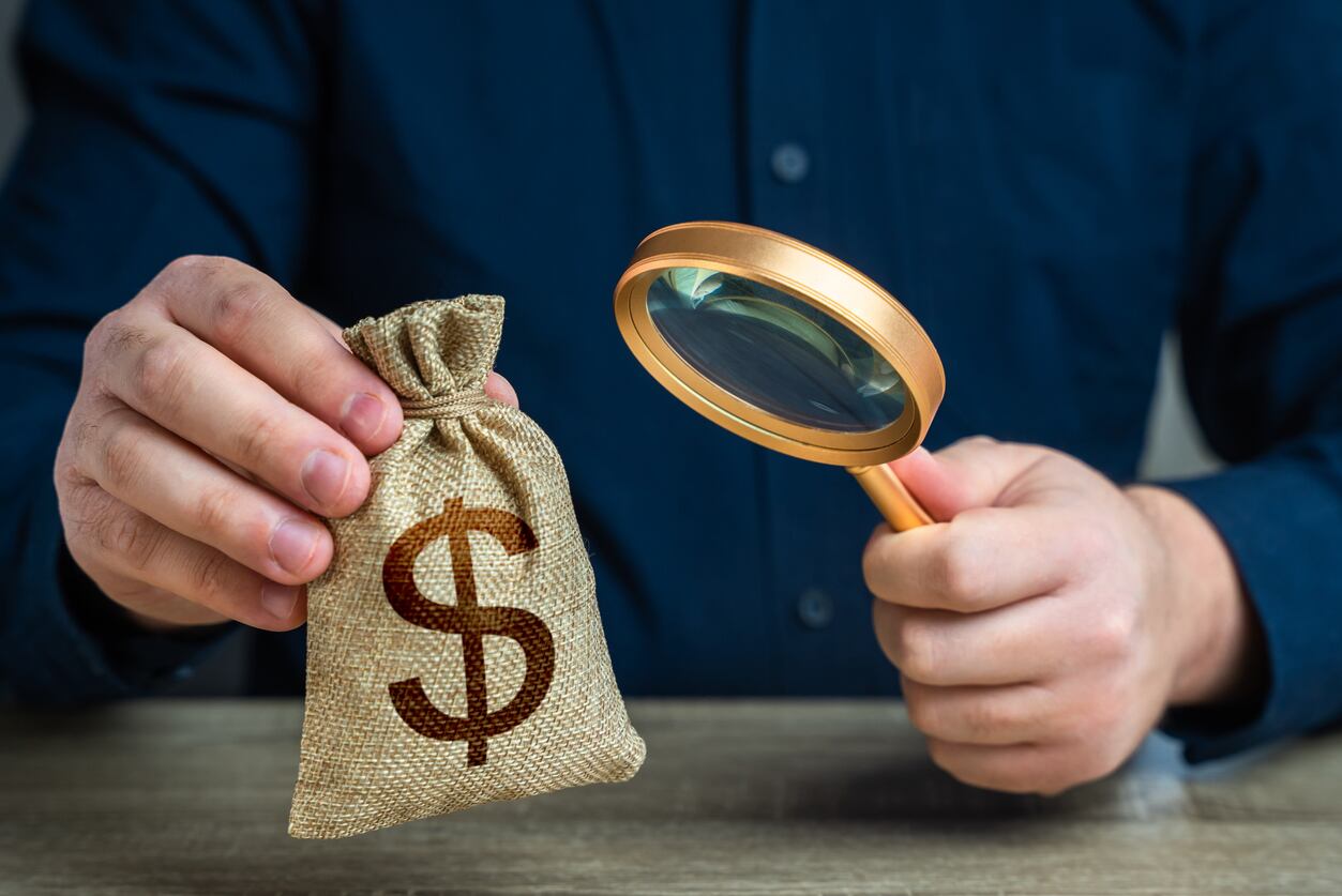 Handcuffs placed on U.S. dollar bills symbolizing financial crimes, federal investigations, and national security risks